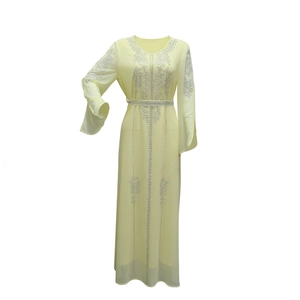 Detail of silver rhinestone floral patterns and belt on pale yellow chiffon long dress