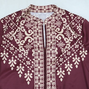 Detail of dark red Jalabiya dress showing stand-up collar, zipper, and floral ethnic patterns