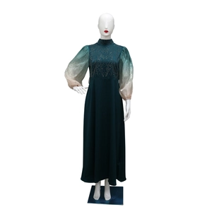 Detail of green jalabiya dress with rhinestone embellishments and gradient puff sleeves