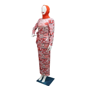 Detail of floral paisley print dress with matching orange hijab and waist bow tie