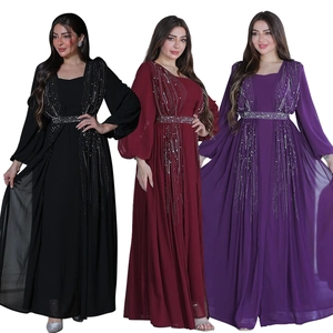 Close-up of rhinestone belts and beaded tassels on elegant long evening gowns