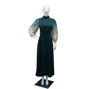 Detail of green jalabiya dress showing gradient bubble sleeves with rhinestone textures