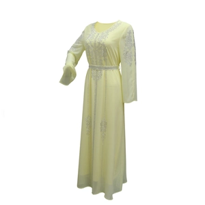 Close-up of sparkling silver rhinestones on light yellow chiffon modest abaya dress