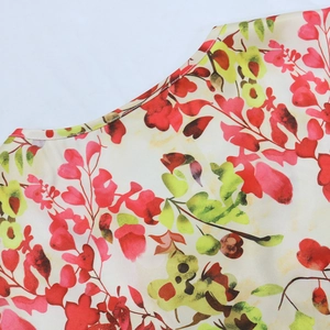 Detail of round neckline and floral print fabric on a lightweight chiffon dress
