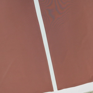 Close-up of terracotta satin fabric with vertical white sequin paneling and mesh texture