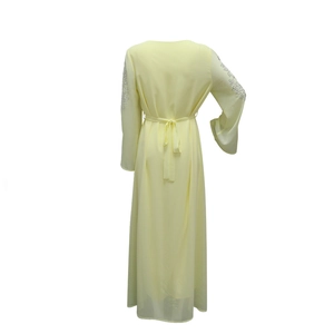 Detailed back view of light yellow chiffon maxi dress with silver rhinestone sleeves