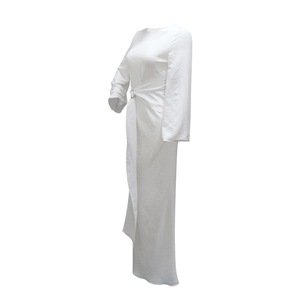 Detail view of white long-sleeved dress featuring waist buckle and elegant draping pleats