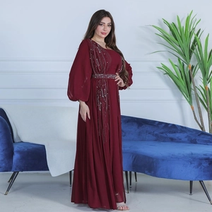 Detail of burgundy chiffon gown featuring intricate sequin embroidery and lantern sleeves