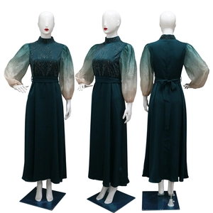 Detail of jalabiya evening dress with gradient puff sleeves and rhinestone patterns