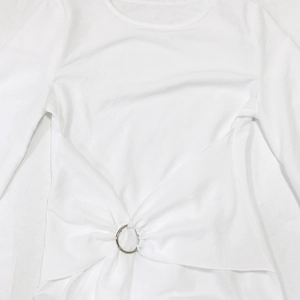 Detailed view of white elegant robe with metal ring waist and pleated cross design