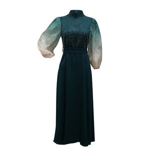 Detail of jalabiya gown featuring gradient puff sleeves and radiant rhinestone patterns