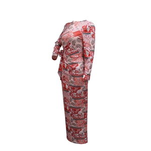 Detail of red floral paisley print on lightweight long sleeve maxi dress with tie waist