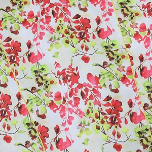 Detail of floral printed fabric featuring deep red and yellow leaves on ivory textile