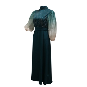 Detail of jalabiya evening dress with gradient lantern sleeves and rhinestone embellishments