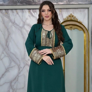 Close-up of golden sequins and lace embroidery on the cuffs of a dark green Jalabiya gown
