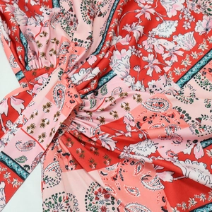 Detailed macro view of bohemian paisley print fabric with central pleated knot design
