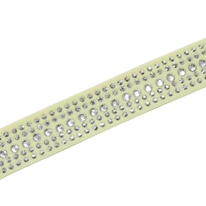 Close-up of sparkling rhinestone patterns on cream chiffon fabric with crystal details