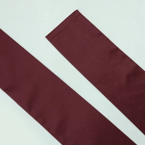 Detailed view of burgundy satin fabric belts with smooth texture and soft luster