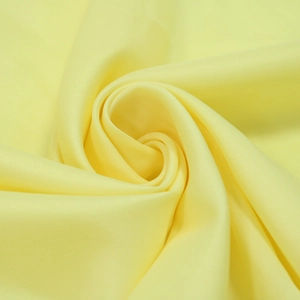 Close-up of lemon yellow chiffon fabric with smooth texture and soft silk-like luster