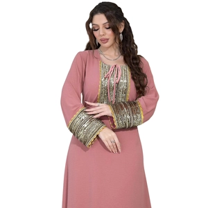 Detailed view of pink Jalabiya with golden sequins, beadwork and delicate lace trim