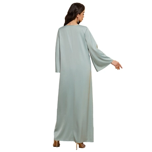Elegant pale green satin abaya dress with long sleeves and loose-fitting flowing silhouette