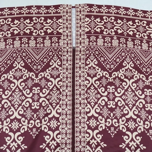 Detail of burgundy ethnic dress showing invisible zipper and white geometric prints