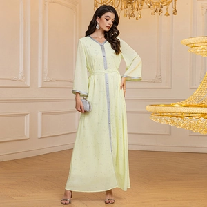 Detail of light yellow chiffon Abaya with silver sequin trim and bow pattern print