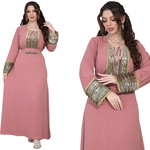 Detail of jalabiya dress with gold sequins, beads, and lace trim on sleeves and neckline