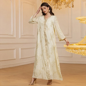 Detail of golden floral embroidery and sequin trim on a champagne chiffon kaftan dress