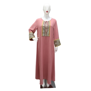 Detail of jalabiya dress showing sequin patchwork lace and drawstring neckline design