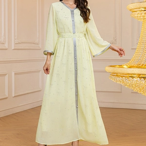 Detail of light yellow chiffon robe with silver sequin butterfly patterns and braided trim