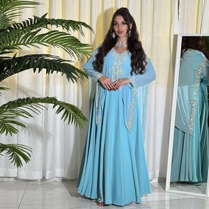Detail of light blue chiffon dress with silver sequin embroidery and wavy edge design