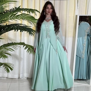 Detail of mint green chiffon maxi dress with silver sequin embroidery on neckline
