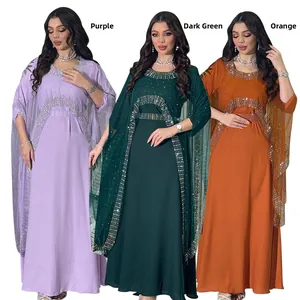 Detail view of rhinestone embellishments on elegant kaftan dresses in three vibrant colors