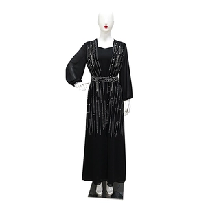 Close-up of black evening gown featuring white rhinestone stripes and beaded waist belt