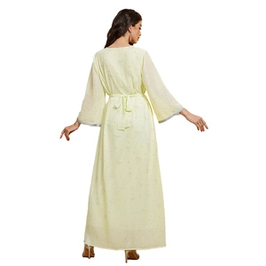 Close-up of light yellow chiffon dress featuring a tie-back bow and flared sleeves
