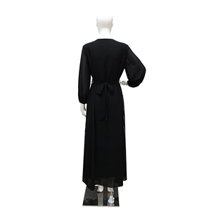 Back view of black long-sleeved Abaya dress with waist tie on a white mannequin