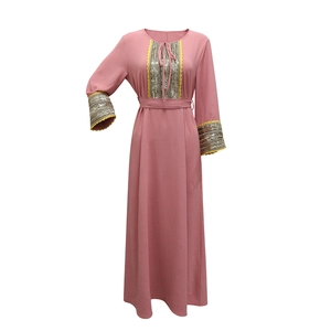 Detail of jalabiya dress with silver sequin panels and yellow wavy lace trim