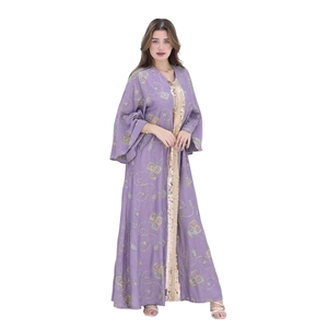 Detailed close-up of golden sequin lace and floral embroidery on a lilac abaya dress