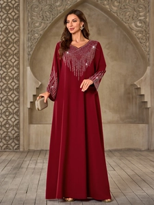 Elegant deep red V-neck maxi dress with silver rhinestones on a centered model