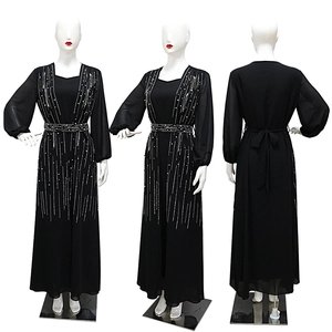 Elegant black long-sleeved evening gown with silver sequins and a belted waist