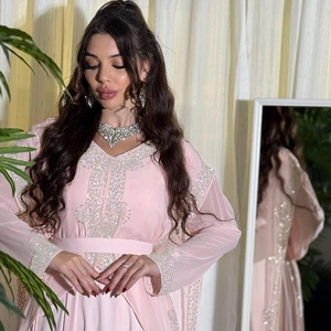 Detailed close-up of light pink chiffon kaftan dress with silver beadwork and sequins