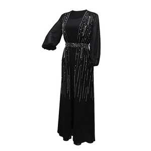 Detail of beaded pearls on black long sleeve chiffon abaya evening gown with belt
