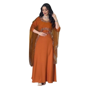 Close-up of bright orange Kaftan with silver sequin beading on neckline and cape sleeves
