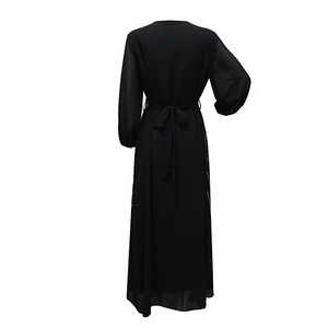 Back view of a black Abaya maxi dress featuring sequins on sides and a waist tie belt