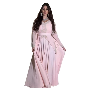 Detail of pink chiffon kaftan dress featuring intricate gold embroidery and sequins