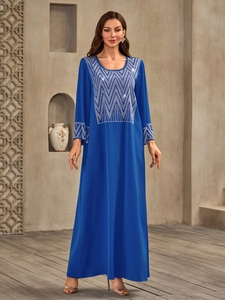 Royal blue long-sleeved Muslim dress with geometric rhinestones in a minimalist setting