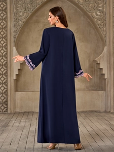Detailed view of navy blue Abaya sleeve with purple and white floral lace embroidery