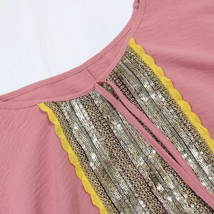 Detail of pink Jalabiya V-neck with gold sequins and yellow scalloped lace trim