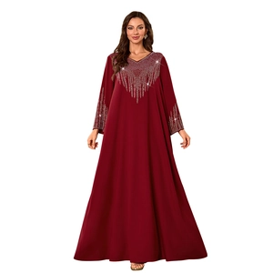 Detailed view of the V-neckline featuring elegant rhinestones on this burgundy maxi dress